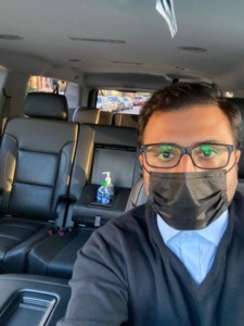 Chauffeur Service waiting in Car wearing mask