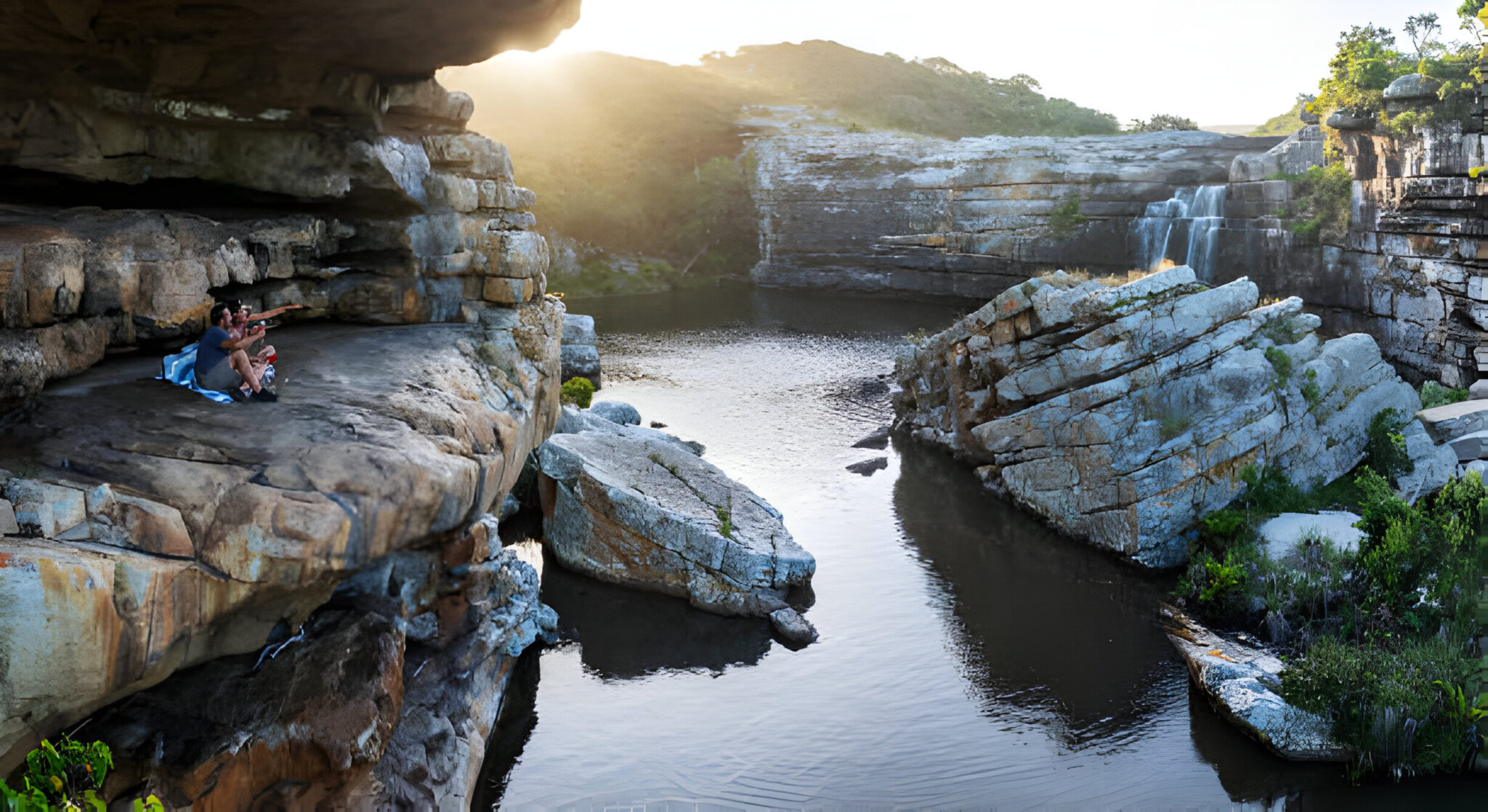 Couple sitting on the rocks beside river